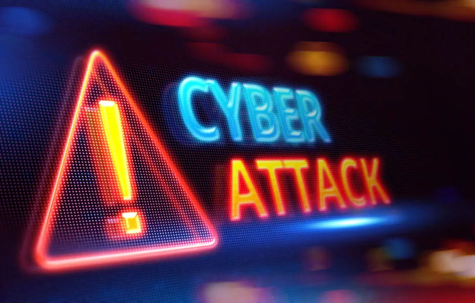 Das Wort Cyber Attack steht in Leuchtschrift mit einem Warnschild
